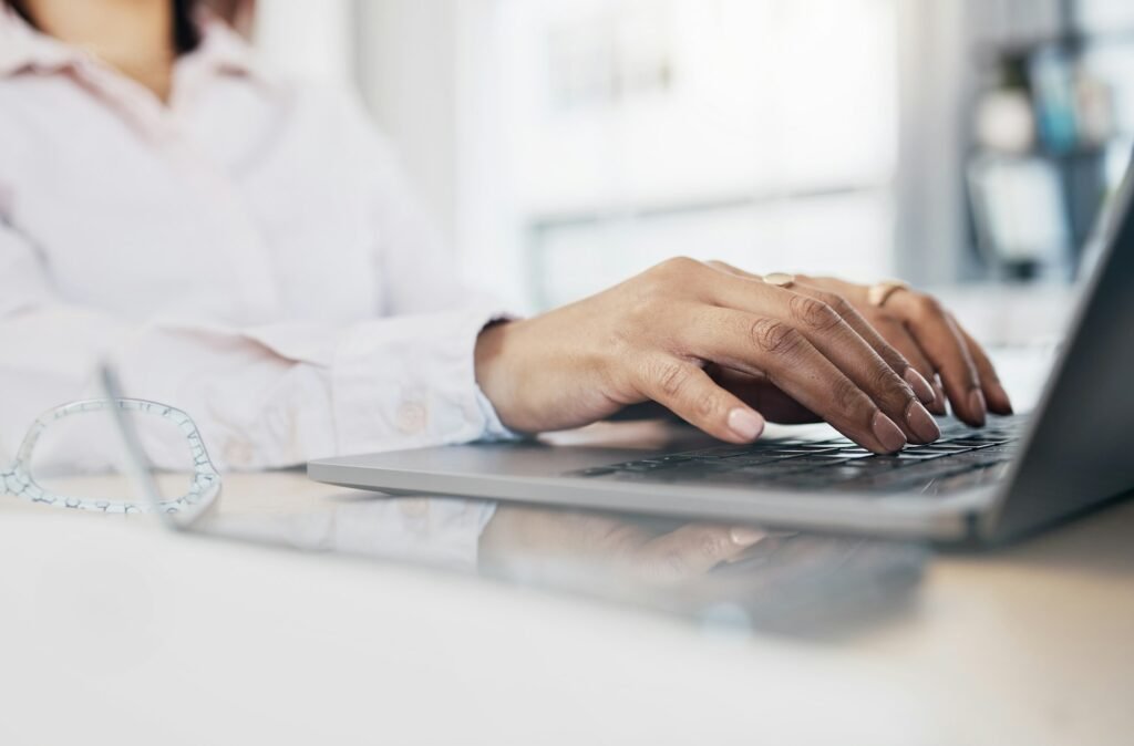 Laptop, hands and business woman typing application wireframe, webdesign or check search engine dev
